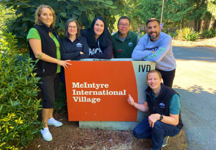 smiling group of adults pose for photo