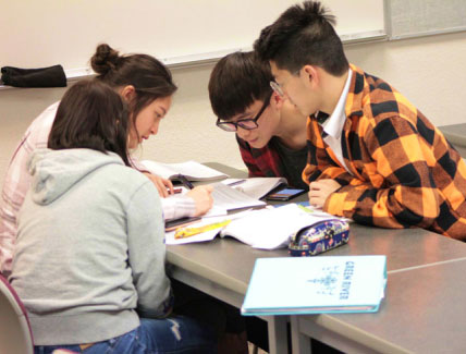 small group of students working together on papers
