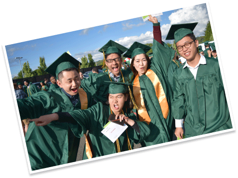 excited graduates posing in robes and caps