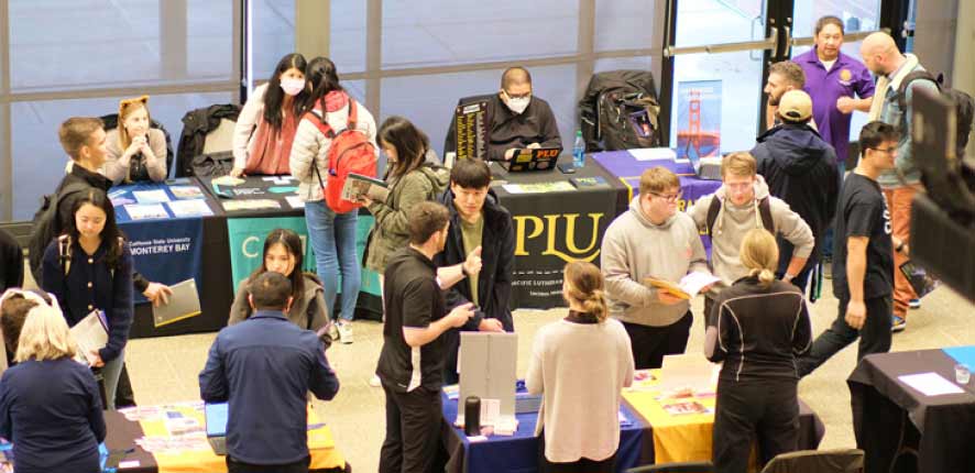 a transfer fair with many tables for different schools